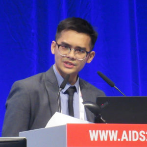 Photo of Akarin Hiransuthikul speaking at podium