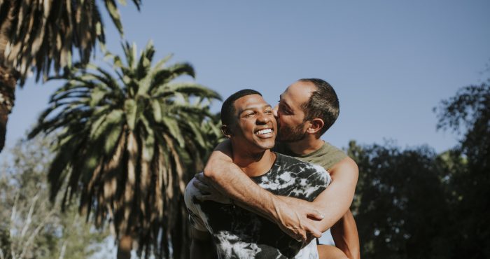 Black man and white man hugging