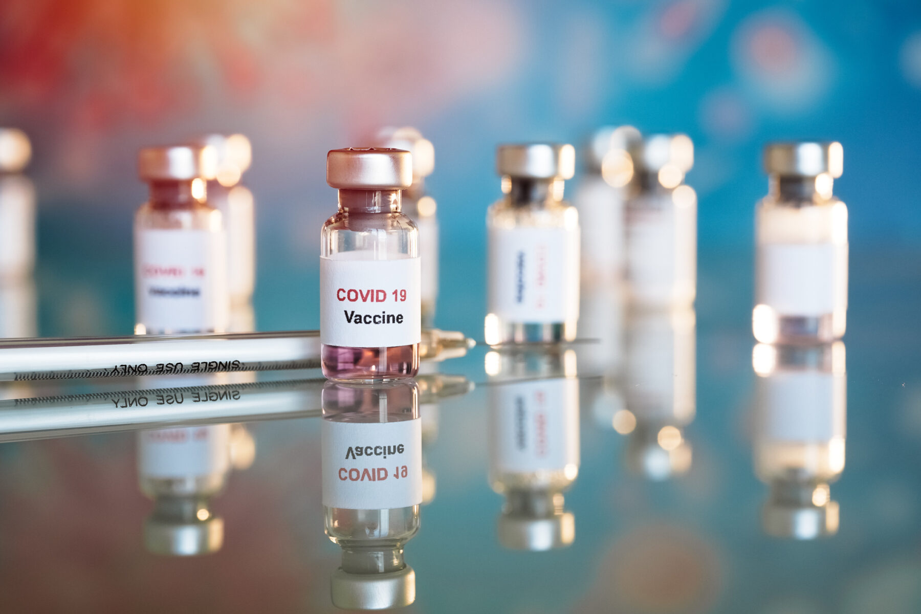 Eight small vials labeled COVID-19 vaccine