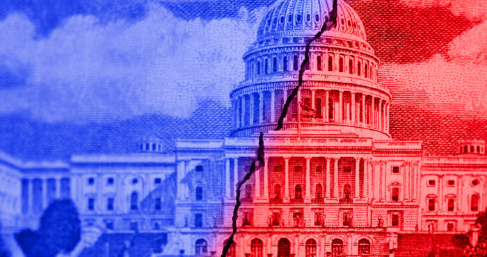 Image of US capitol building, split in half and outlined in red and blue, showing polarized politics in the U.S.
