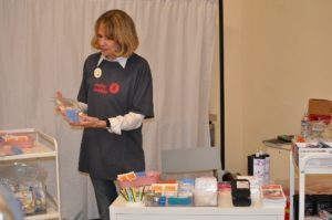 A volunteer for the Glide overdose prevention facility demonstration, Safer Inside, shows harm reduction supplies that would be provided to visitors at an overdose prevention site. 