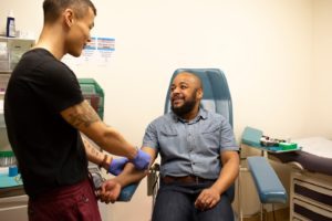 Image of man receiving hiv test in doctor's office