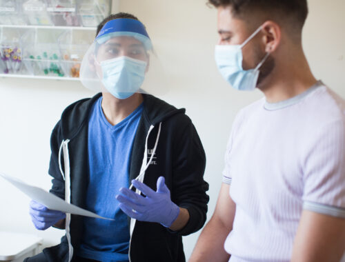 Person receiving health care wearing mask