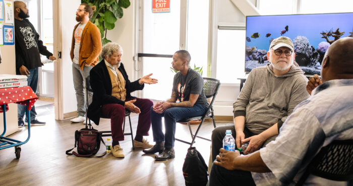 People sitting in a room talking in pairs