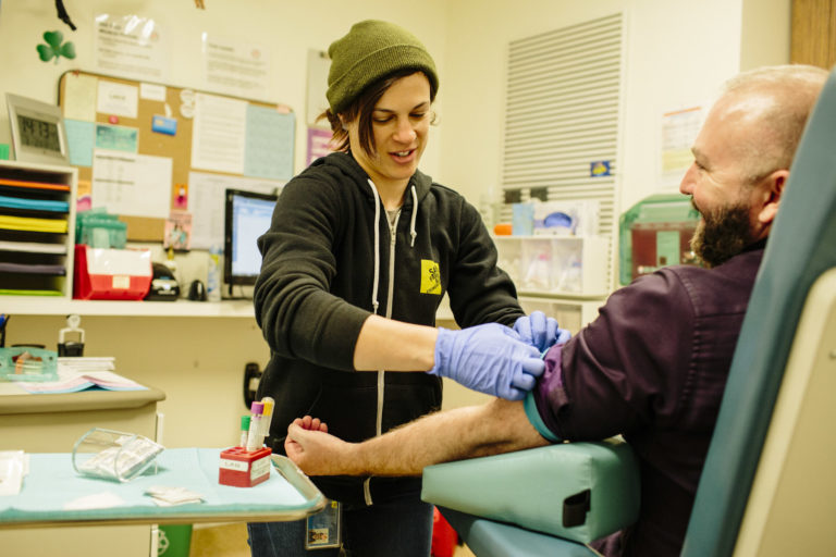 Stut employee administering a HIV test to a patient