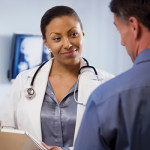 doctor reviewing medical chart with patient