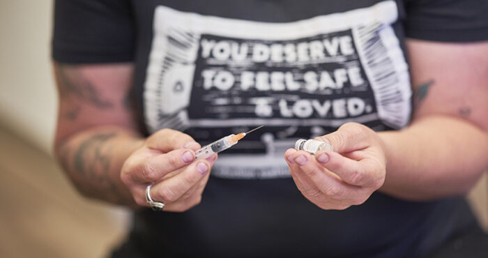 Person holding syringe with Narcan