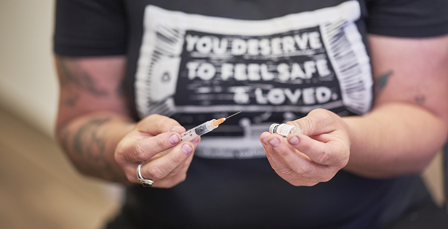 Person holding syringe with Narcan