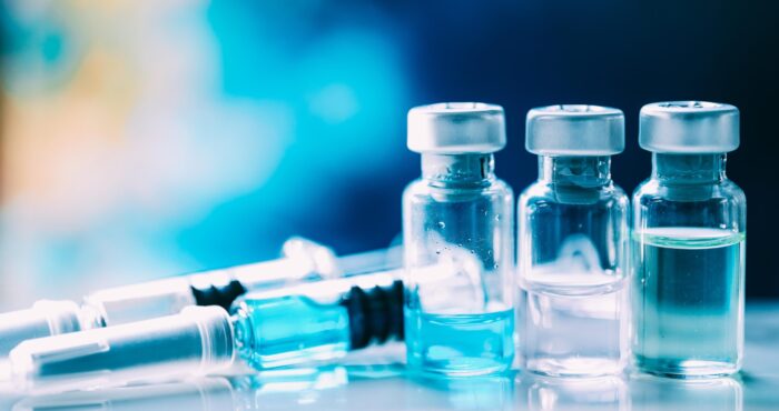 stock photo of vials of clear liquid and syringe