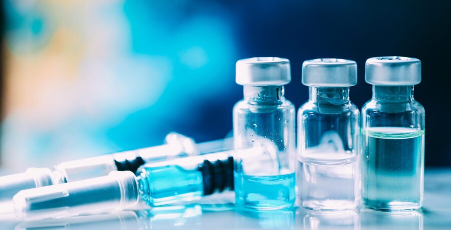 stock photo of vials of clear liquid and syringe