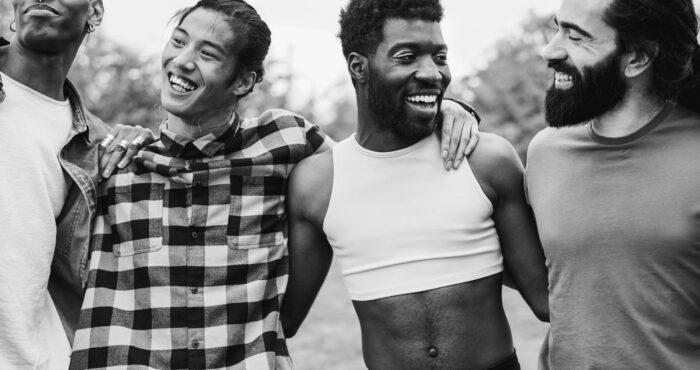 Diverse group of men hugging