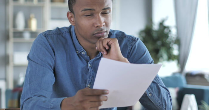 young man looking at paper