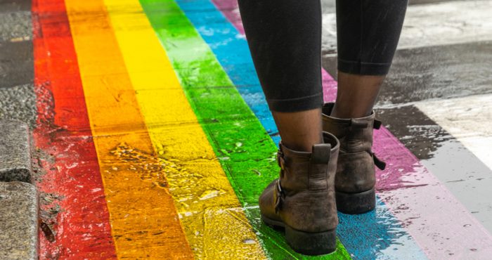 Person walking on rainbow sidewalk