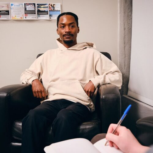 A man meets with a licensed mental health practitioner during a behavioral health counseling session at San Francisco AIDS Foundation.